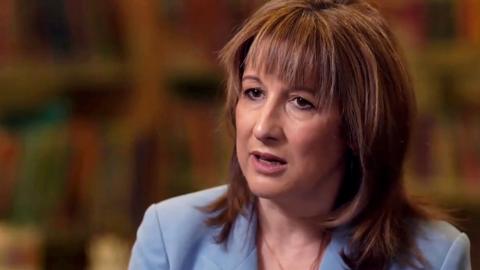 Chancellor Rachel Reeves, sitting down being interviewed, wearing a light blue suit jacket