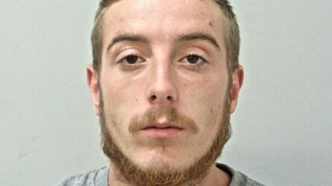 Jez Shepherd's mugshot. He  has dark brown eyes, and mousey short hair, moustache and chin beard