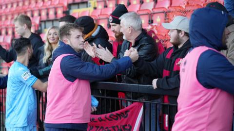 Truro City's players show their appreciation to their travelling fans after the draw at Gateshead