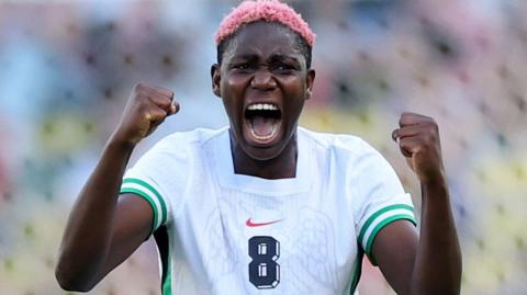 Asisat Oshoala celebrates while playing for Nigeria
