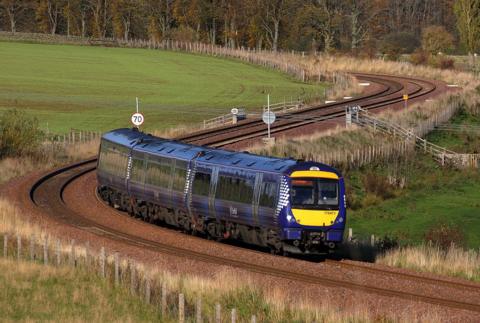 A train on a bend in the Borders Railway travelling through the countryside