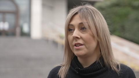 Aimee Coombes, who has blonde hair and is wearing a black jumper