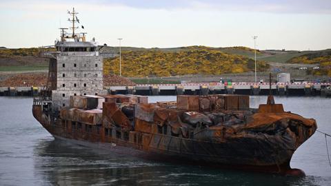 The Solong with damage to its bow and burn marks along the hull and bridge area 
