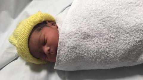 Newborn baby wrapped up in a towel