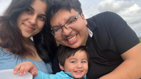 Isabella Morris and her husband and two-year-old son pose for a picture