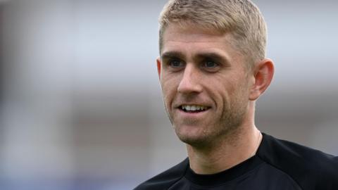 Olly Stone smiling