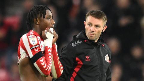 Romaine Mundle is helped off the pitch by a physio in the 2-2 draw with Coventry