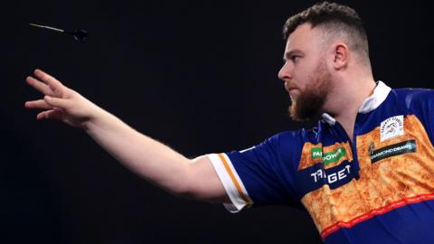 Josh Rock throws a dart
