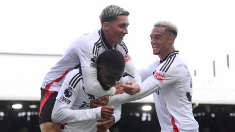 Alex Iwobi of Fulham celebrates scoring against Leicester