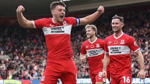 Middlesbrough captain Dael Fry has his arms outstretched in celebration after scoring the opening goal in Boro's victory over Birmingham City. Team-mates Alan Brown and Riley McGree rush to congratulate the club's skipper