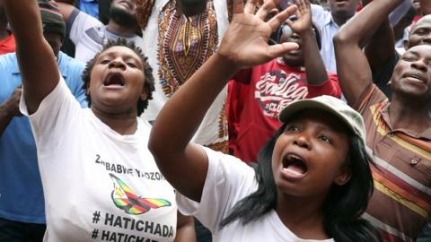 Opposition MDC supporters sing outside party headquarters following the Zimbabwe election, 31 July 2018