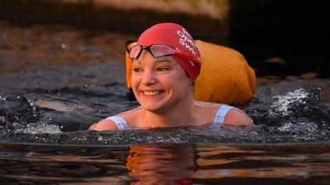 Woman swimming in the West Reservoir Lake in East London