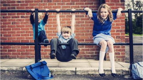 Three children in school uniform