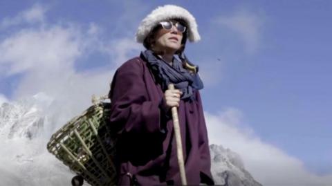 Elise against the backdrop of mountains in Tibet