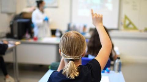 Pupil in facemask in school