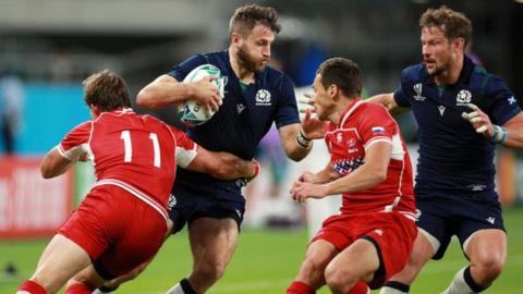 Tommy Seymour of Scotland is tackled by Vladislav Sozonov of Russia during the Rugby World Cup 201