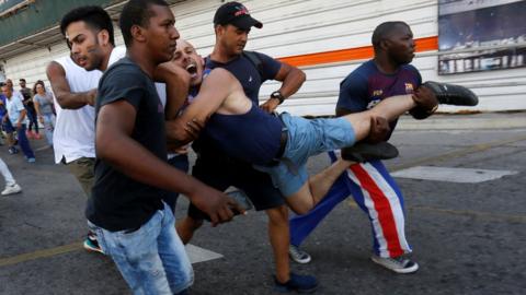 A Cuban LGBT activist is detained by plain-clothed security personnel while participating in an annual demonstration against homophobia and transphobia in Havana, 12 May 2019