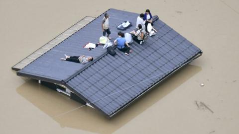 People on a roof in Japan.