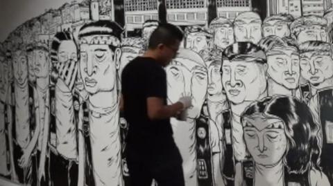 Singapore street artist with his artwork