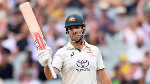 Australia's Mitchell Marsh raises his bat for 50 against Pakistan