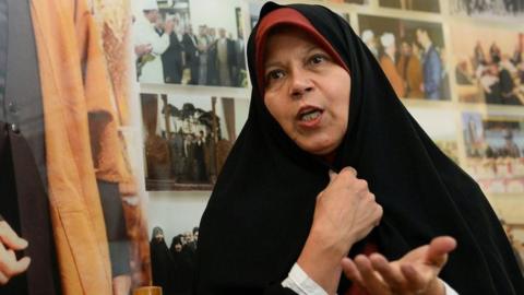 File photo showing Faezeh Hashemi speaking next to a photo of her father, Akbar Hashemi Rafsanjani (11 January 2019)