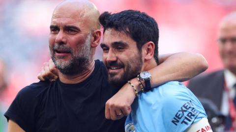 Ilkay Gundogan celebrates with Pep Guardiola