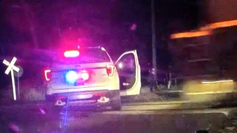 Dash camera footage captured the terrifying moment the train hit a parked police car in the US state of Denver