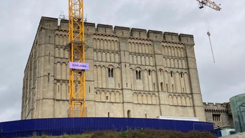 Norwich Castle on 20 March 2023 with a crane next to it