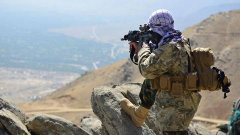 An Afghan resistance movement and anti-Taliban uprising forces takes a postion during a patrol on a hilltop in Darband area in Anaba district, Panjshir province on September 1, 2021