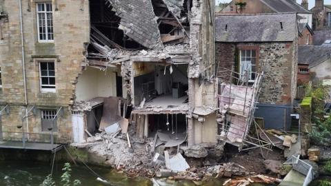 The damage to the rear of the building next to the river