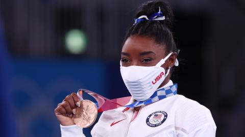 Simone Biles with her bronze medal