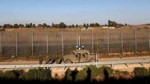 Israeli soldiers patrol the ceasefire line between Israel and Syria, as seen from the Israeli-occupied Golan Heights