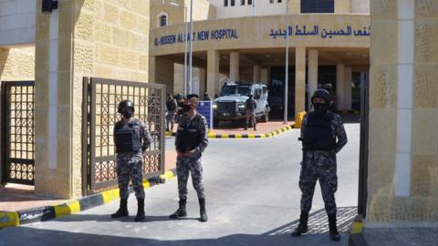 Gendarmerie officers stand guard at the gate of the new Salt government hospital in Jordan, 13 March 2021