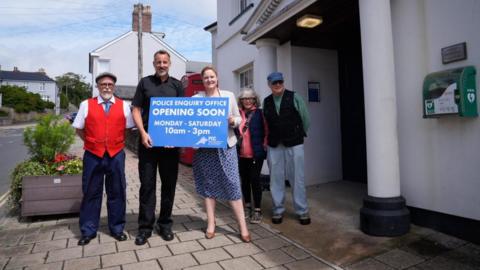 Devon and Cornwall Police and Crime Commissioner Alison Hernandez with a police officer and local residents outside Kingsbridge's police station