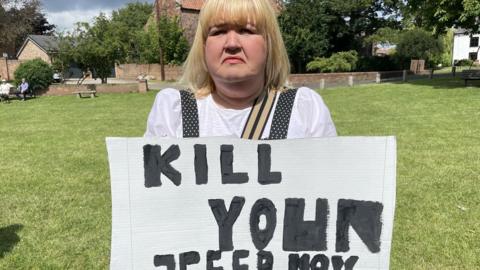 Joanne Dent with "Kill your speed now" placard