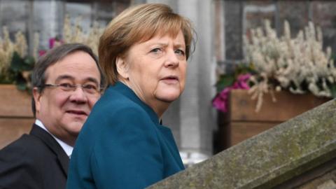German Chancellor Angela Merkel (R) and the State Premier of North Rhine-Westphalia Armin Laschet arrive to attend the signature ceremony of a French-German friendship treaty, on January 22, 2019