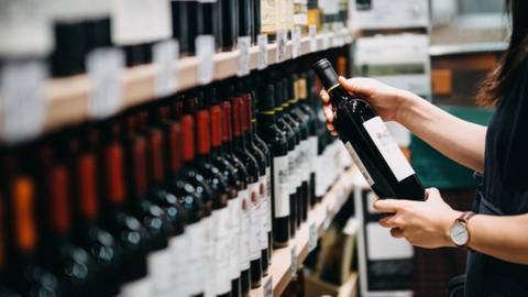 Woman choosing a bottle of wine