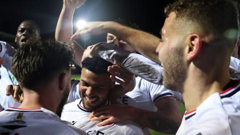 Bolton players celebrate with goalscorer Elias Kachunga