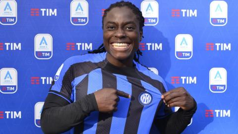 Tabitha Chawinga points at Inter Milan crest on her top