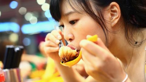 Woman eating dumplings