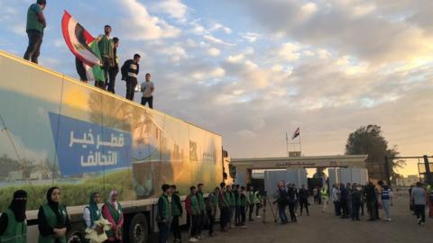 An aid convoy waits on the Egyptian side of the Rafah crossing on 17 October