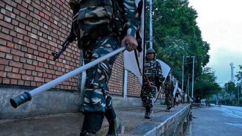 Security personnel patrol during a lockdown in Srinagar