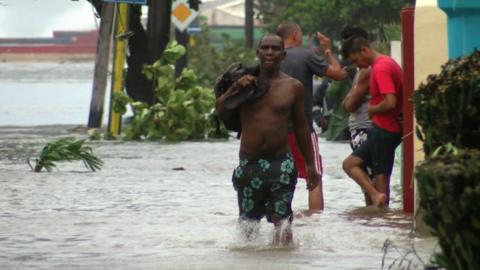 A man walks through flood water