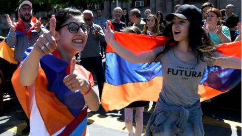 Supporters of Armenian opposition leader Nikol Pashinyan dance at the central square of Yerevan on May 2, 2018