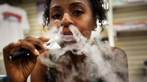 Gabrielle Ortiz smokes an electronic cigarette at Vape New York