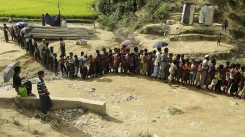 Rohingya refugees queue at a camp in Bangladesh