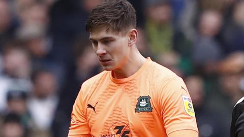 Michael Cooper goes off injured during Plymouth's defeat to Sheffield Wednesday