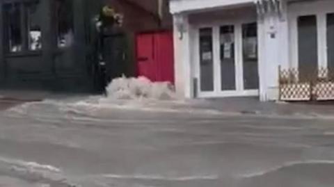 Water bursting out of sewer