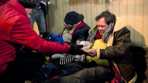 two homeless men during a visit of a team of the Red Cross that searches the streets of Brussels for homeless people, on February 1, 2012.