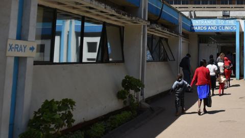 People walk in front of Kenya's oldest hospital, Kenyatta National Hospital (KNH) in Nairobi on 23 January 2018